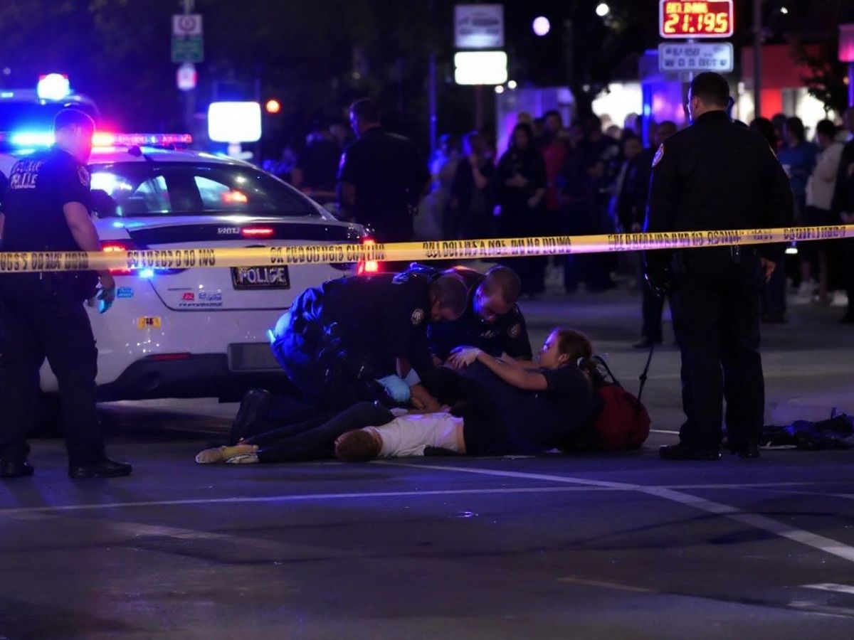 Police car and emergency responders at accident scene.